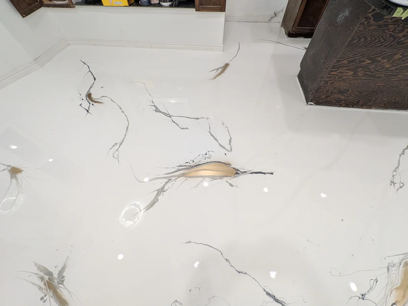 Yamo metallic epoxy installation with pale grey, white and gold flowing patterns